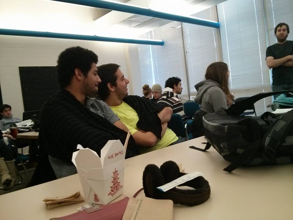 Two subjects sharing a blanket in a classroom